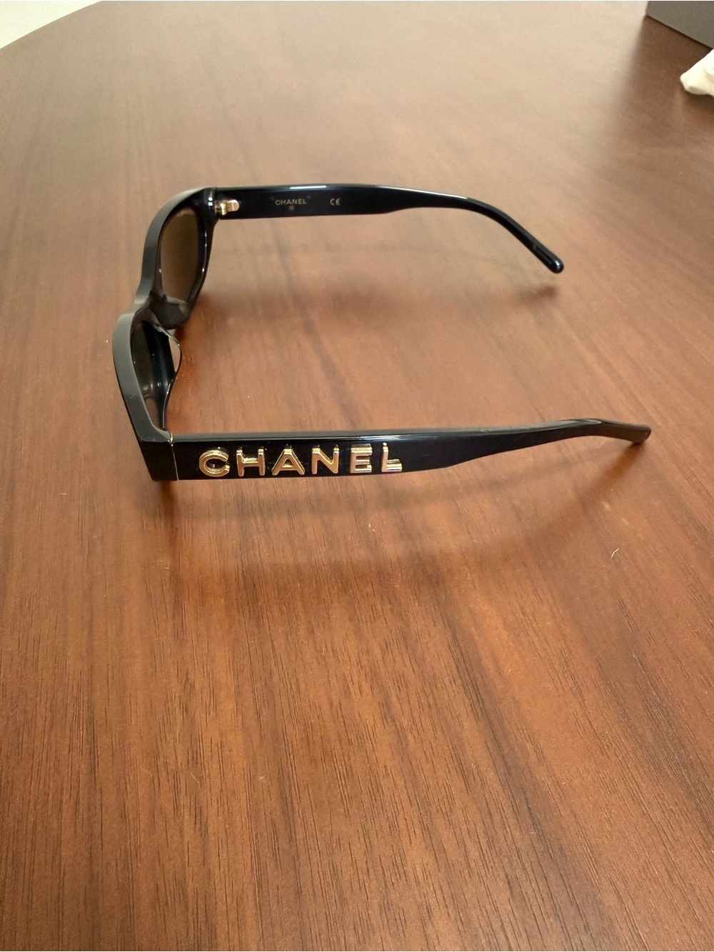 CHANEL Black Sunglasses with Gold Lettering